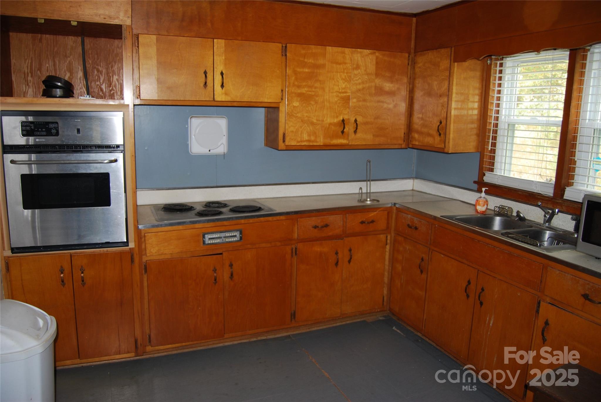 7 Noble Road Fairview, NC 28730 - Photo 25 of 44 a kitchen with stainless steel appliances granite countertop a sink a stove and a microwave