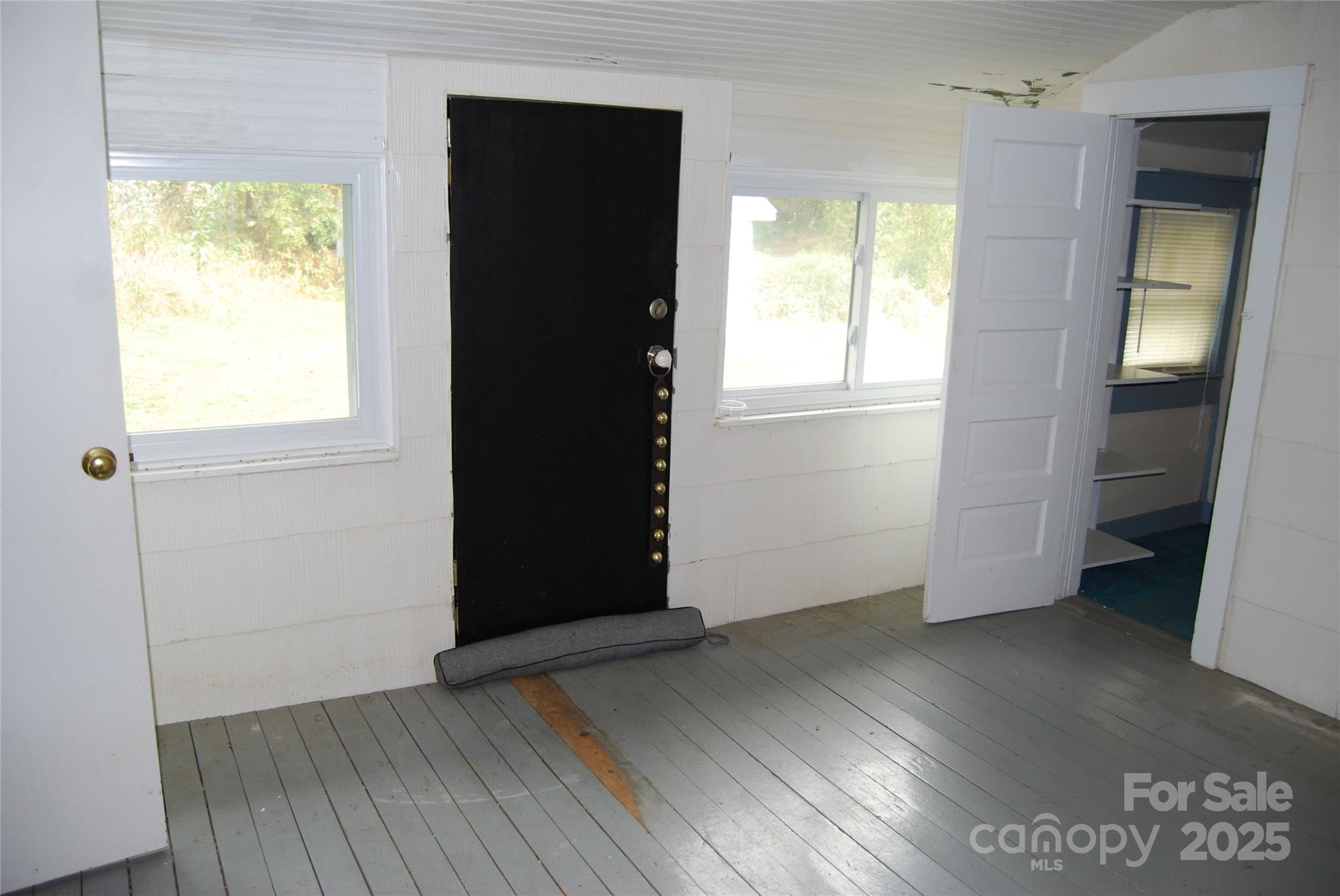 7 Noble Road Fairview, NC 28730 - Photo 26 of 44 an empty room with wooden floor and windows