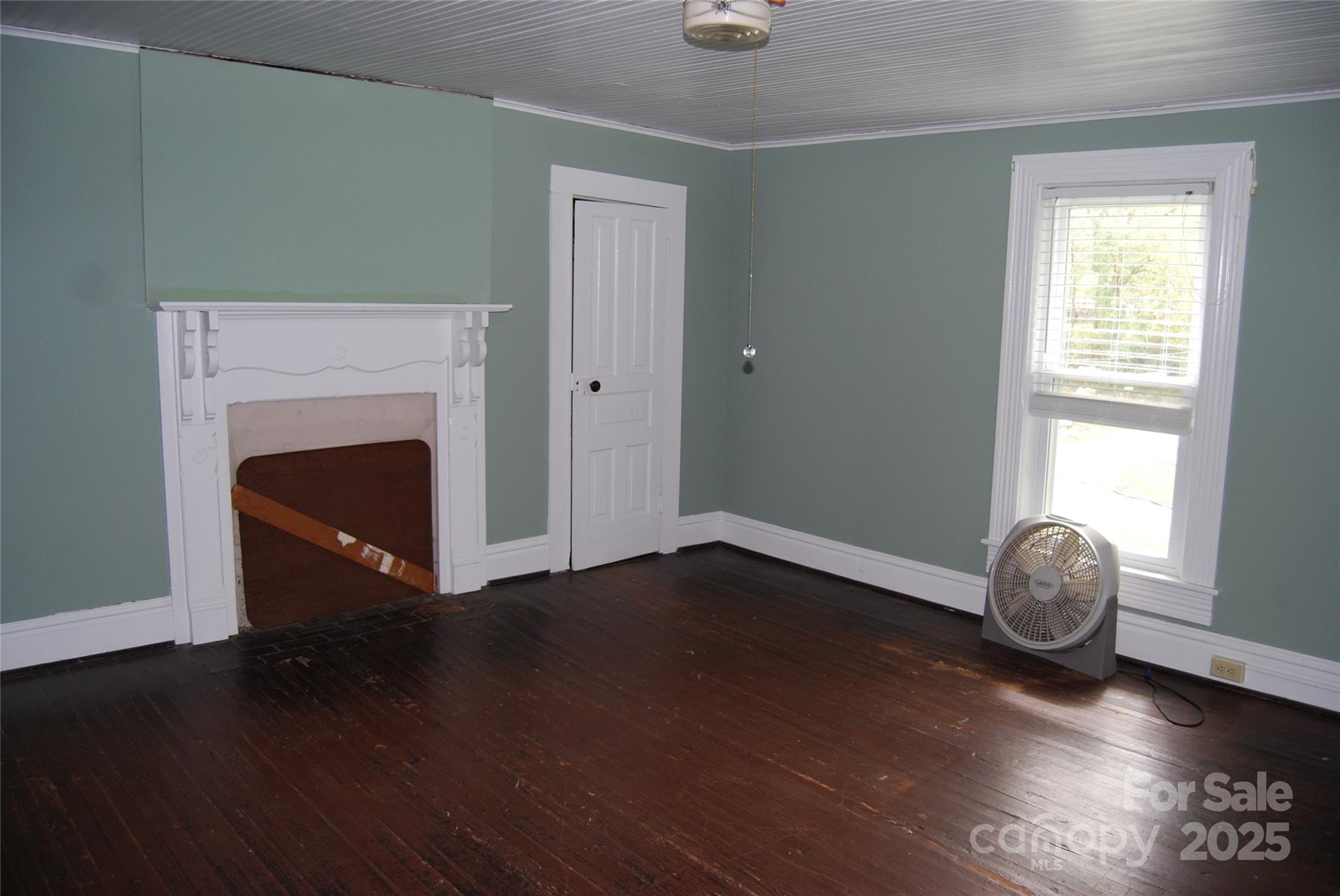 7 Noble Road Fairview, NC 28730 - Photo 27 of 44 an empty room with wooden floor and fireplace
