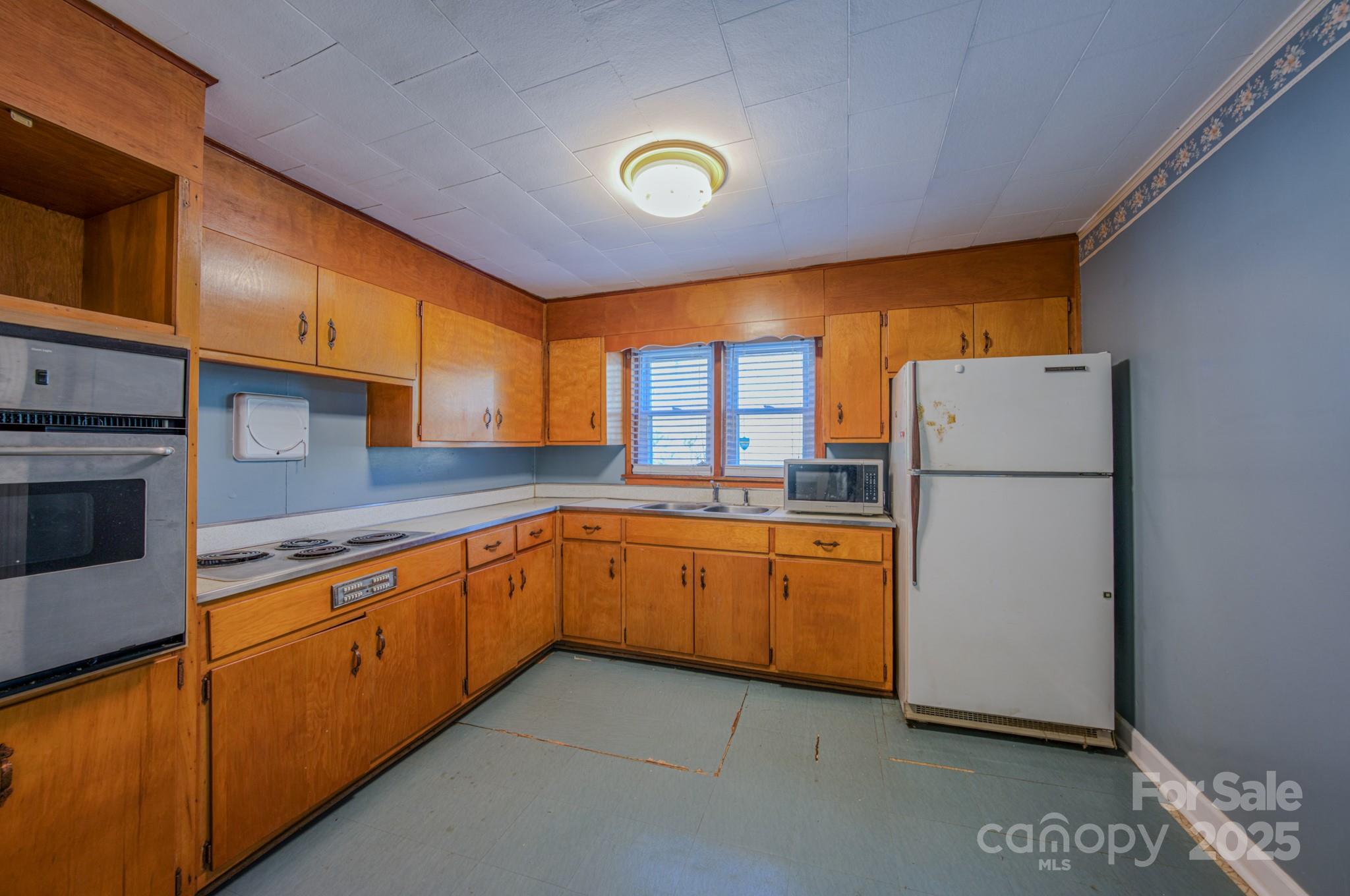 7 Noble Road Fairview, NC 28730 - Photo 36 of 44 a kitchen with stainless steel appliances granite countertop a refrigerator a oven a sink with granite countertops and cabinets