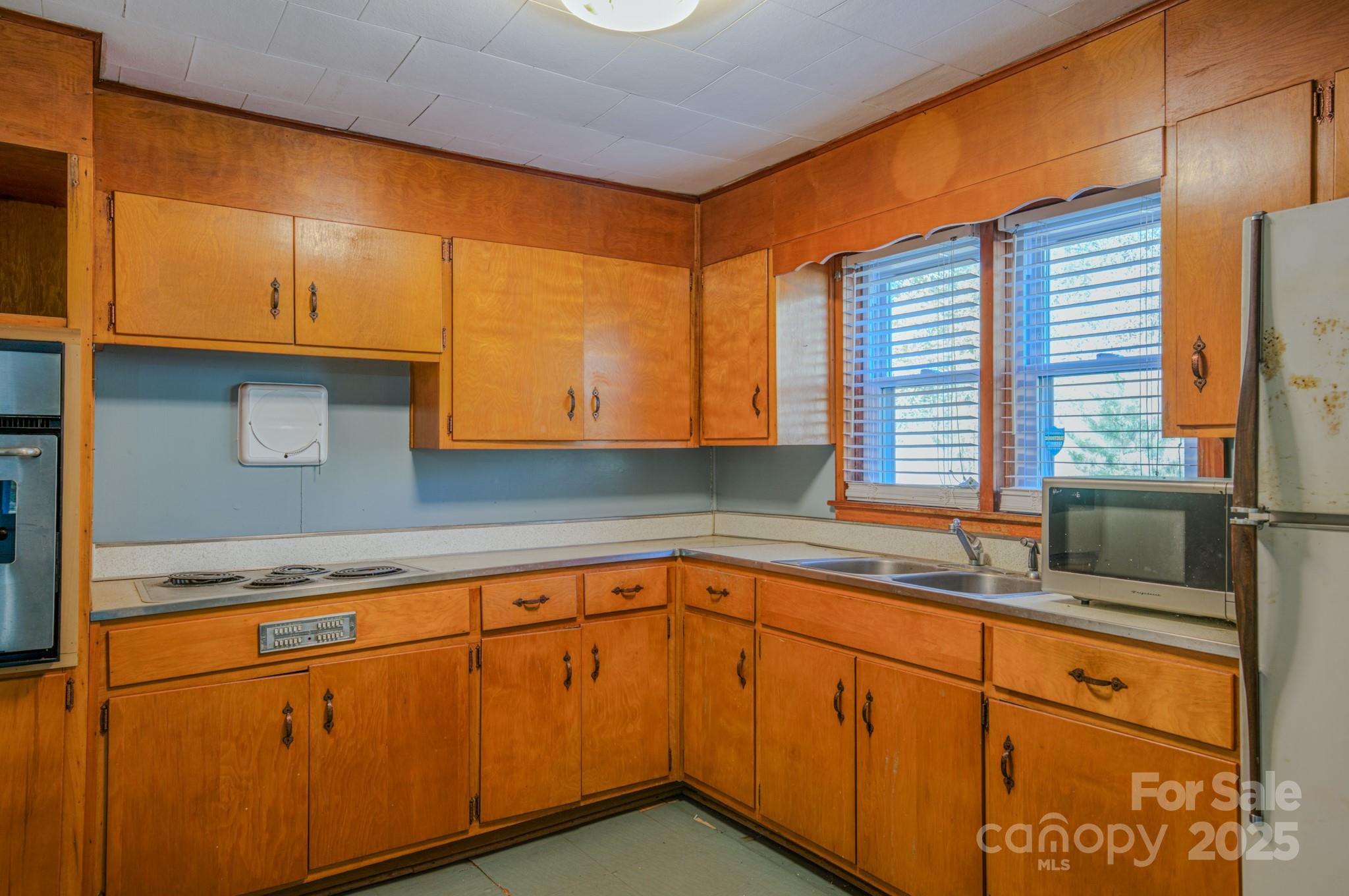7 Noble Road Fairview, NC 28730 - Photo 37 of 44 a kitchen with granite countertop cabinets sink and window
