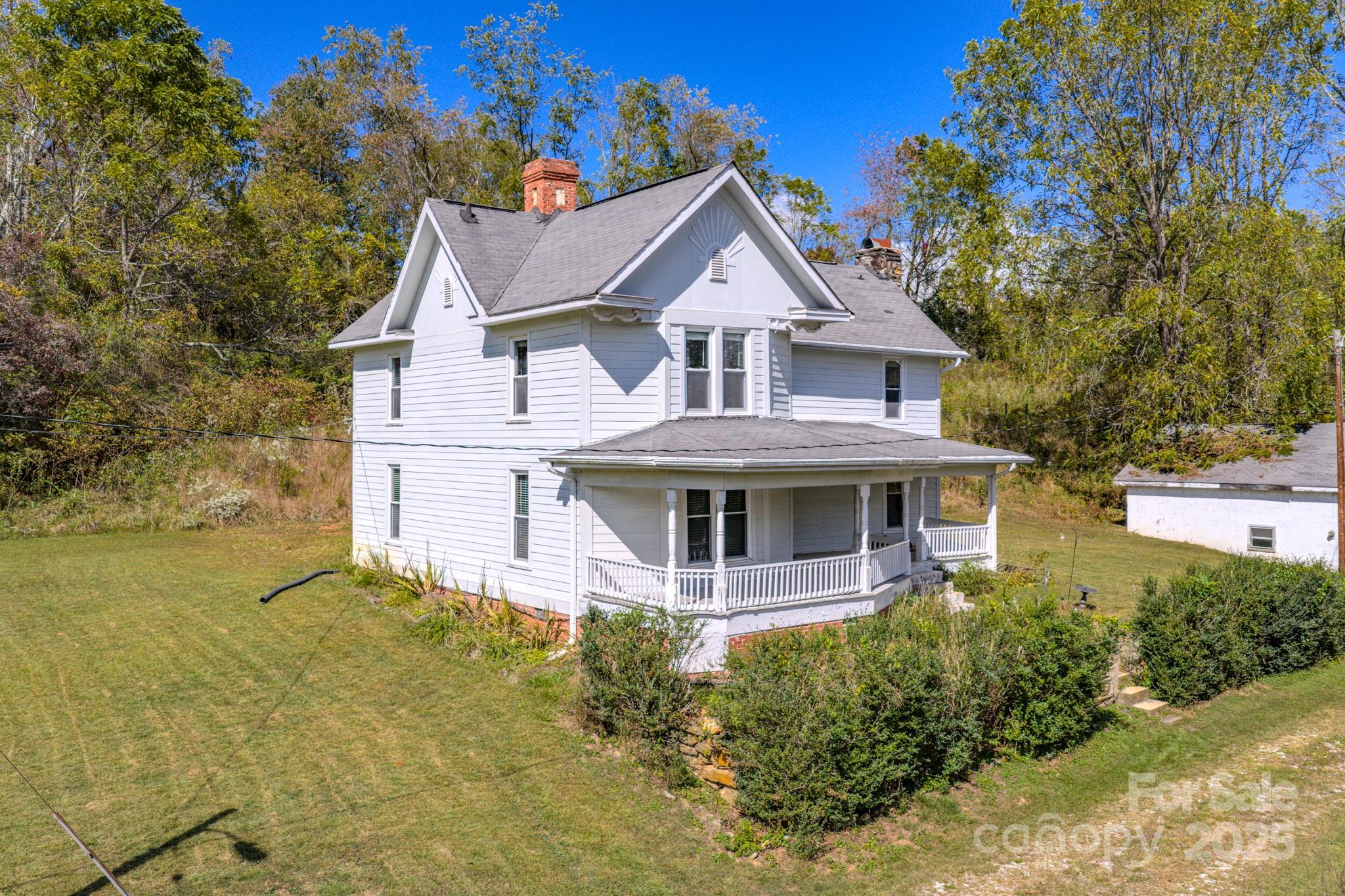 7 Noble Road Fairview, NC 28730 - Photo 4 of 44 a front view of a house with garden