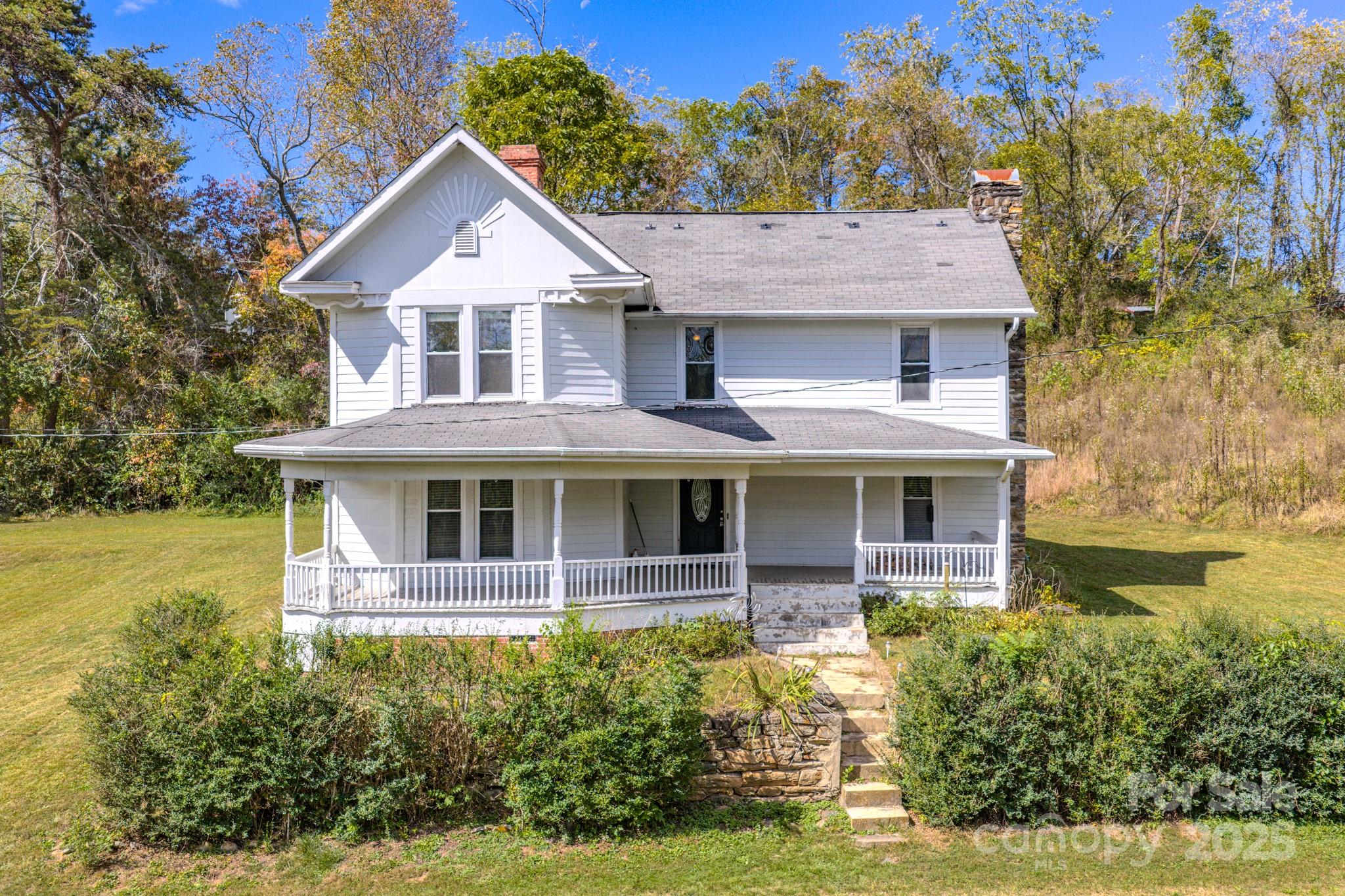7 Noble Road Fairview, NC 28730 - Photo 5 of 44 a front view of a house with garden