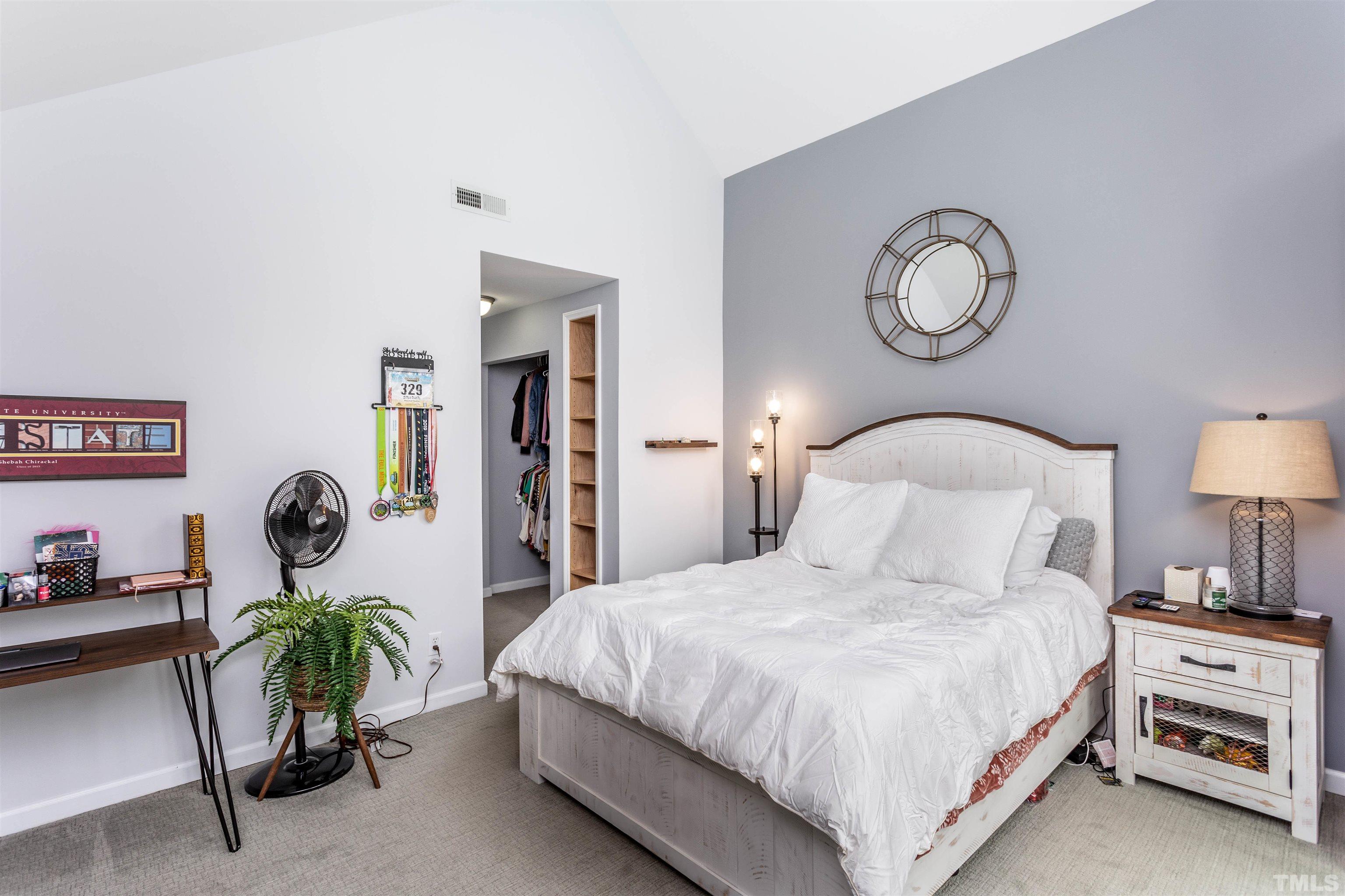 1024 Brighthurst Drive Raleigh, NC 27605 - Photo 17 of 26 a bedroom with bed and a chandelier