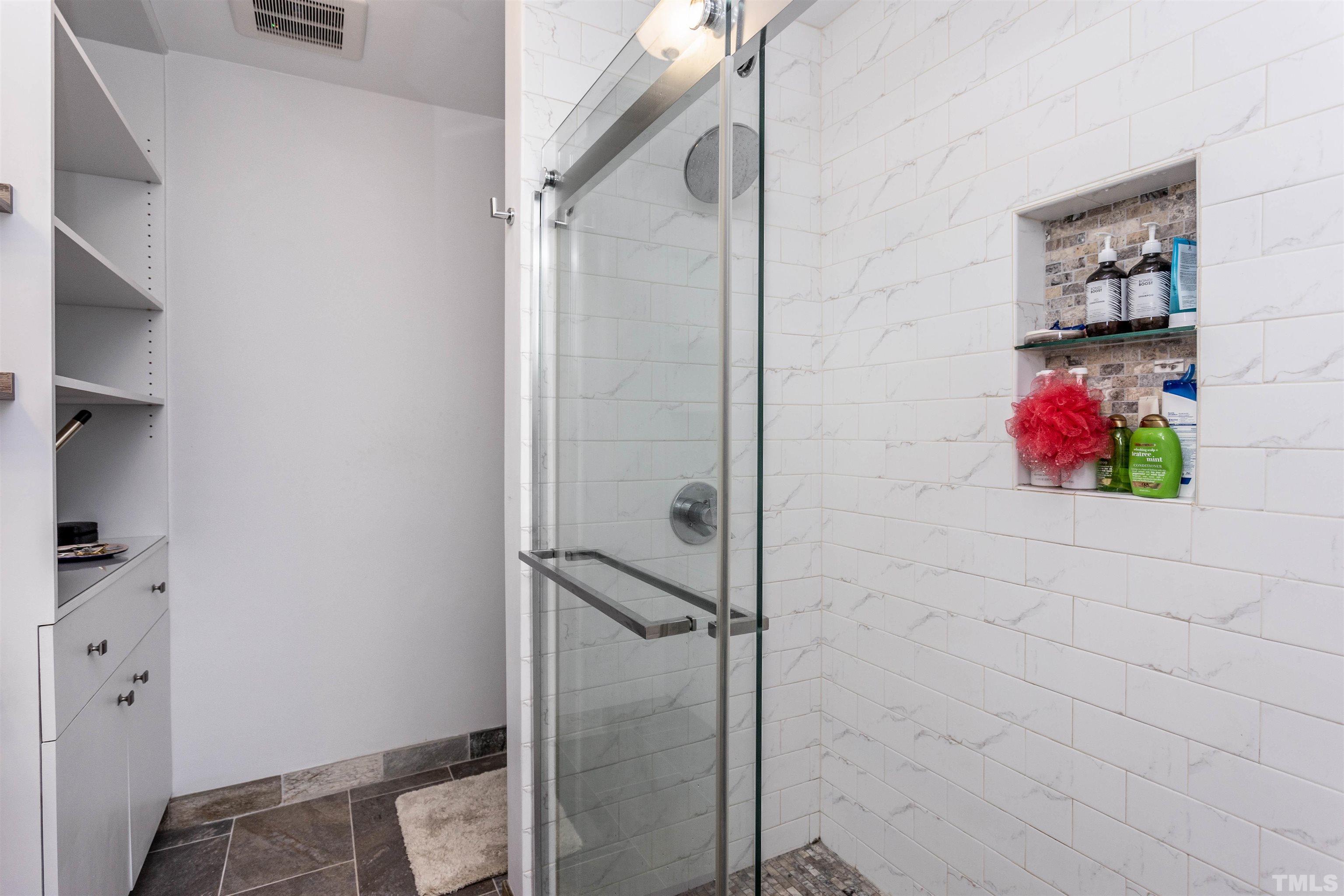 1024 Brighthurst Drive Raleigh, NC 27605 - Photo 19 of 26 a bathroom with a shower and a potted plant on th wall