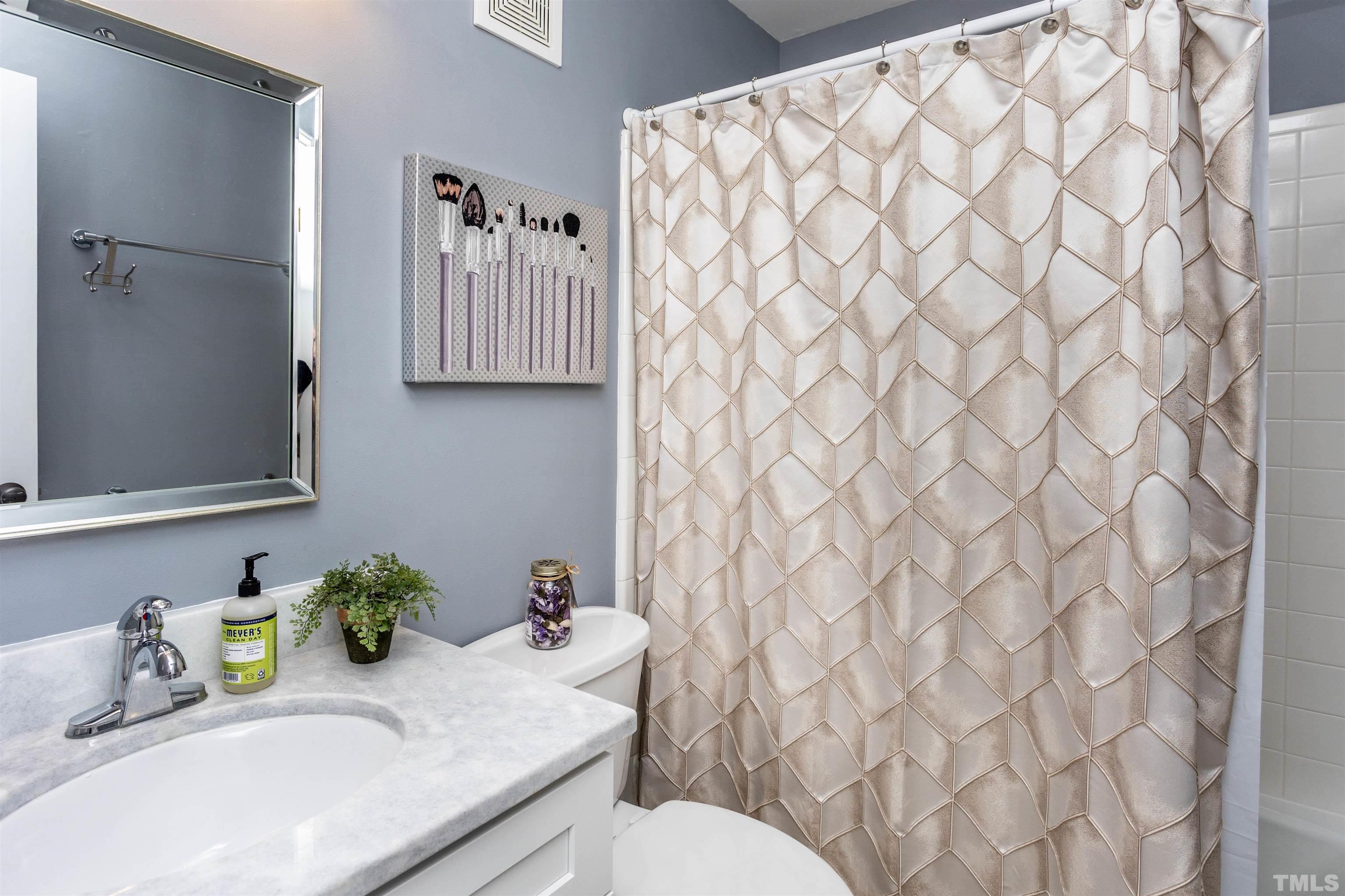 1024 Brighthurst Drive Raleigh, NC 27605 - Photo 22 of 26 a bathroom with a granite countertop sink and a toilet