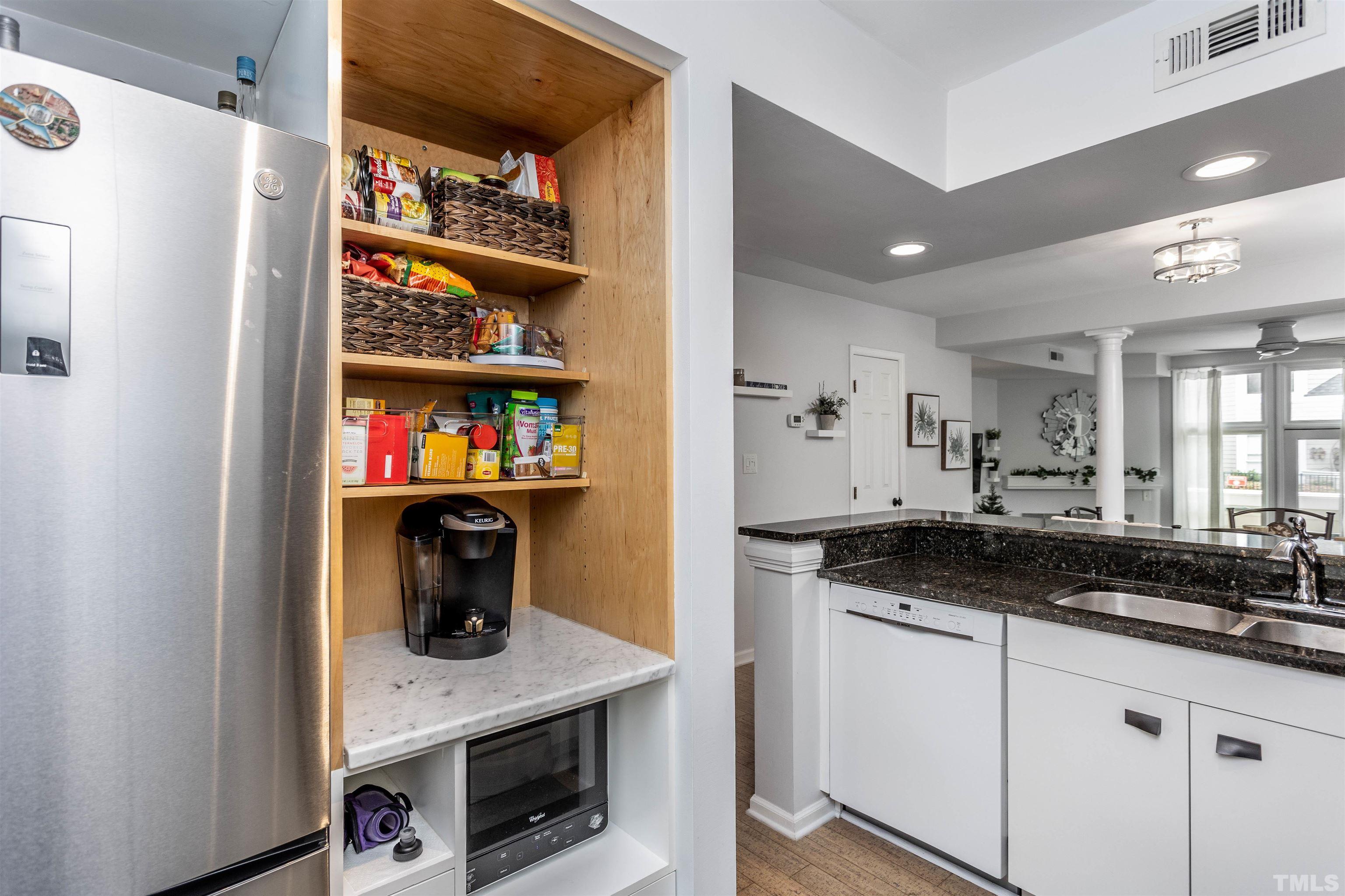 1024 Brighthurst Drive Raleigh, NC 27605 - Photo 6 of 26 a kitchen with stainless steel appliances granite countertop a sink a stove and a refrigerator with wooden floor