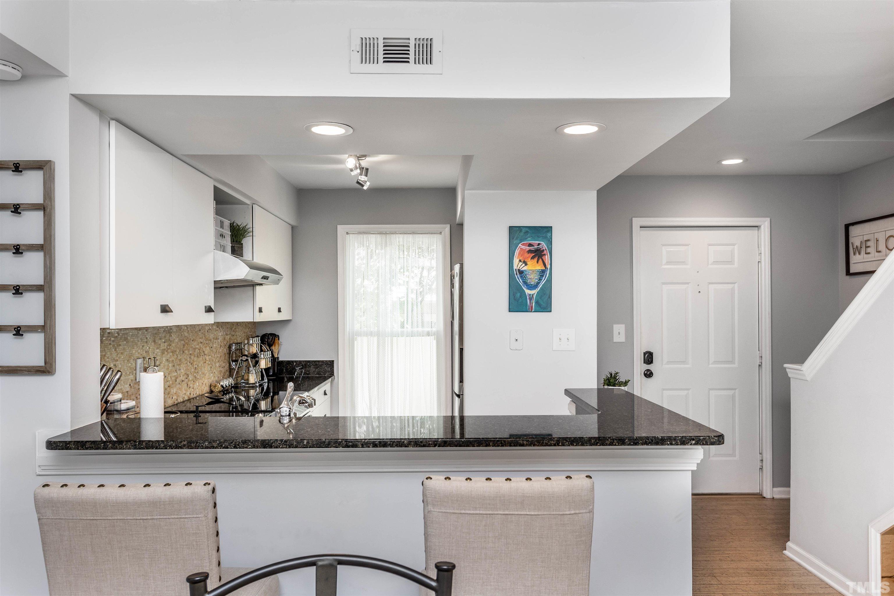 1024 Brighthurst Drive Raleigh, NC 27605 - Photo 8 of 26 a kitchen with granite countertop a sink and a refrigerator