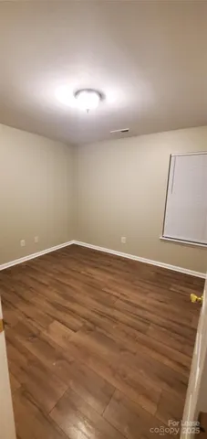 a view of room with wooden floor