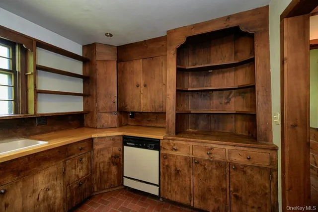 a kitchen with white cabinets and a sink