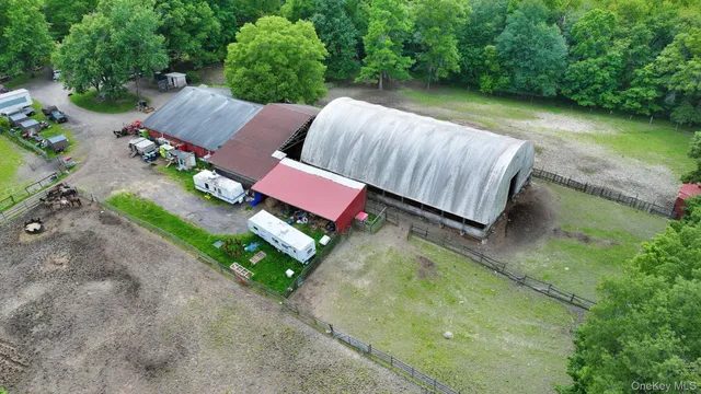 an aerial view of a house with a yard and lake view