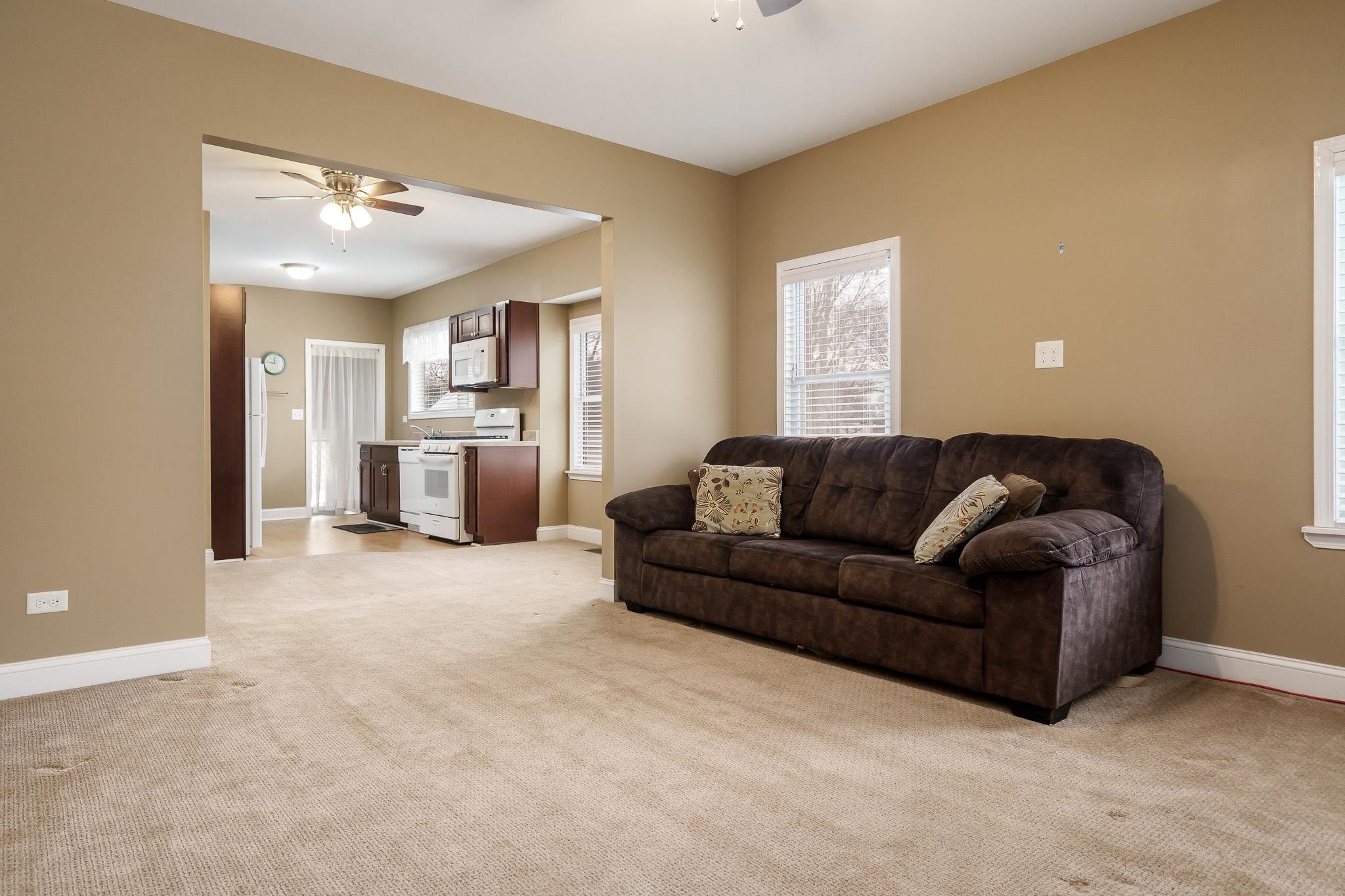 720 South 2nd Street DeKalb, IL 60115 - Photo 3 of 20 a large living room with a couch and a window