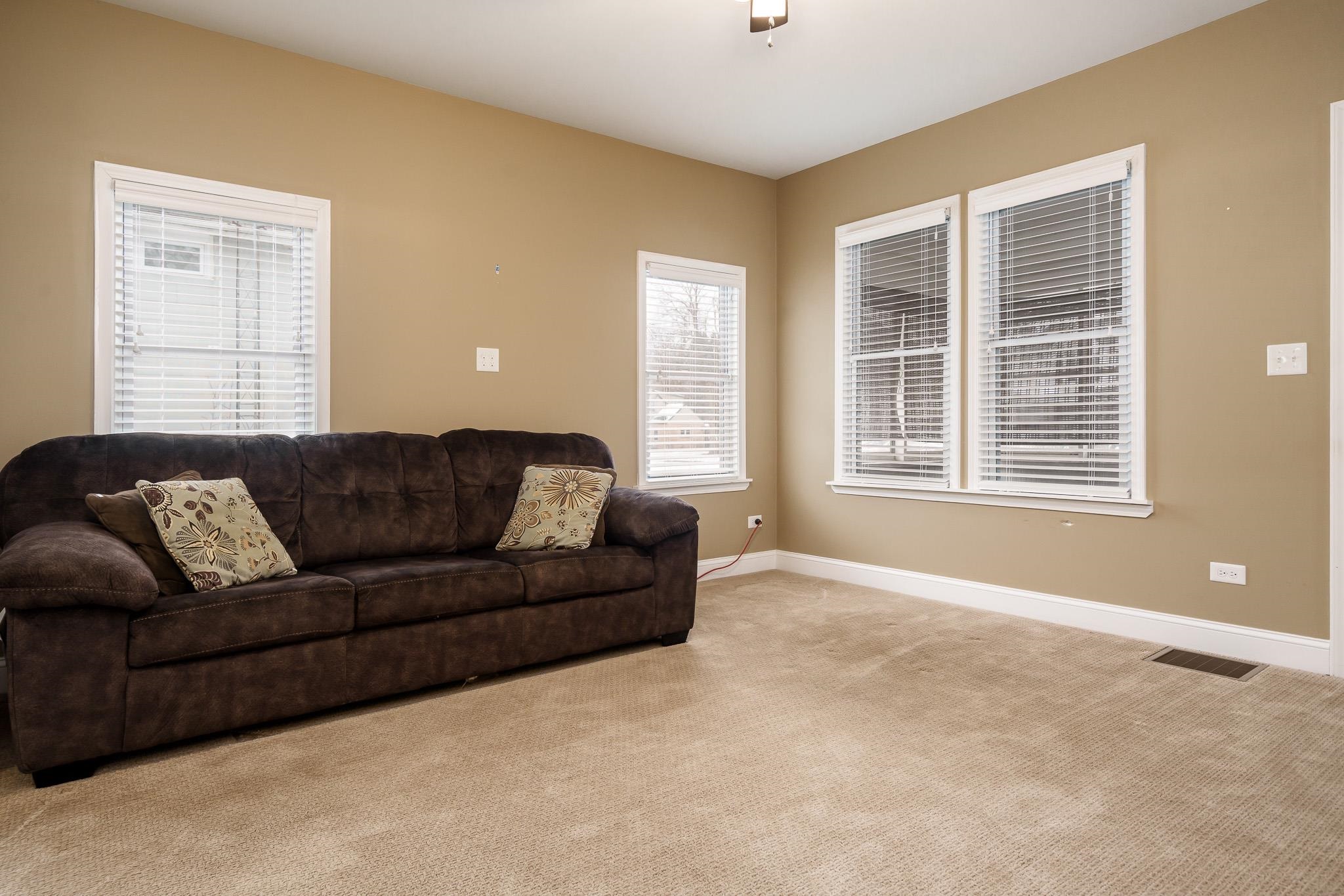 720 South 2nd Street DeKalb, IL 60115 - Photo 5 of 20 a living room with a couch and a window