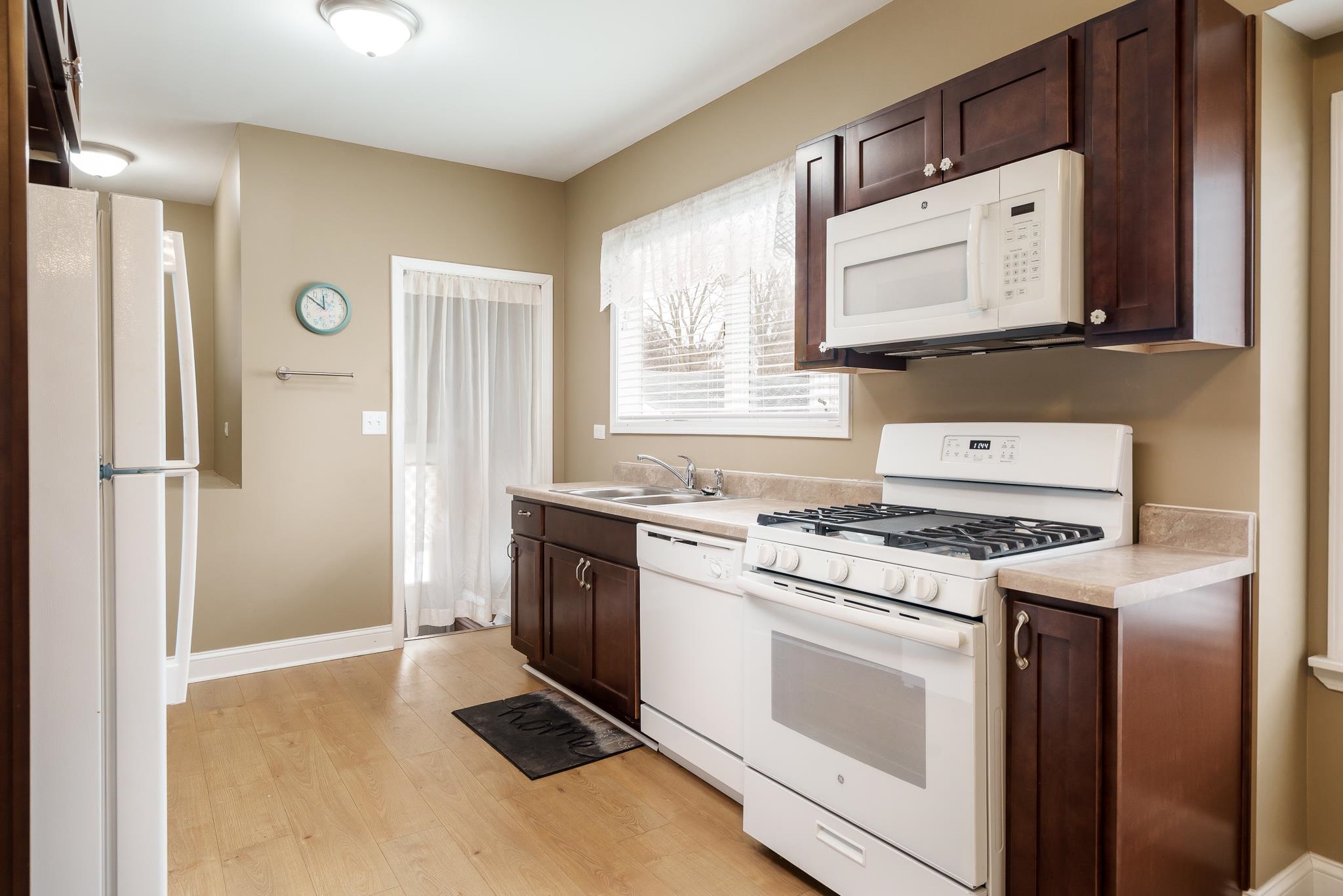 720 South 2nd Street DeKalb, IL 60115 - Photo 9 of 20 a kitchen with a stove top oven sink and refrigerator