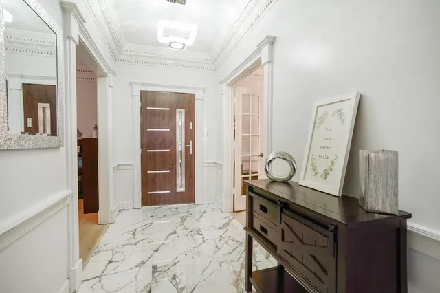 a view of a hallway with entryway door