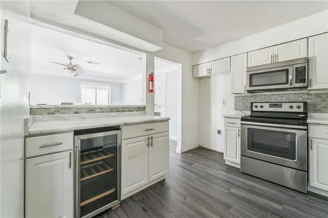a kitchen with stainless steel appliances granite countertop a stove and a refrigerator
