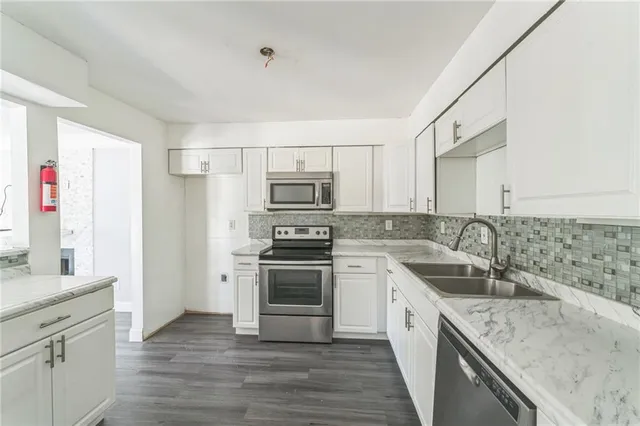 a kitchen with a sink stove and refrigerator