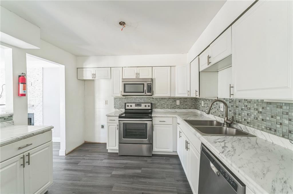 18 Quail Run, Unit A Decatur, GA 30035 - Photo 12 of 28 a kitchen with a sink stove and refrigerator