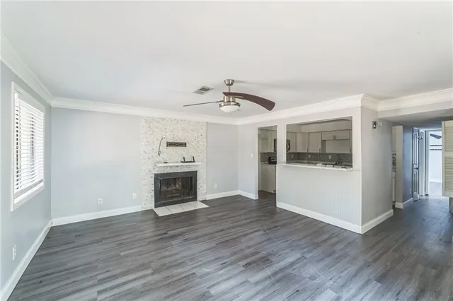 a view of an empty room with a fireplace and a window