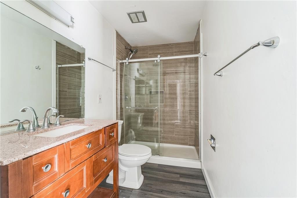 18 Quail Run, Unit A Decatur, GA 30035 - Photo 22 of 28 a bathroom with a granite countertop sink toilet and shower