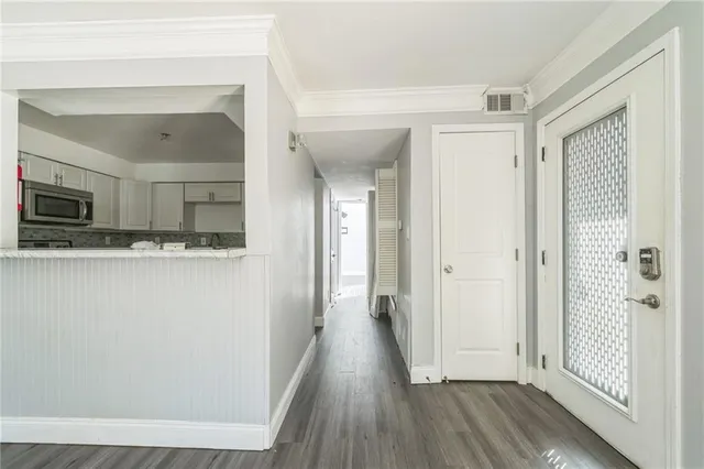 a view of a hallway view of wooden floor and staircase