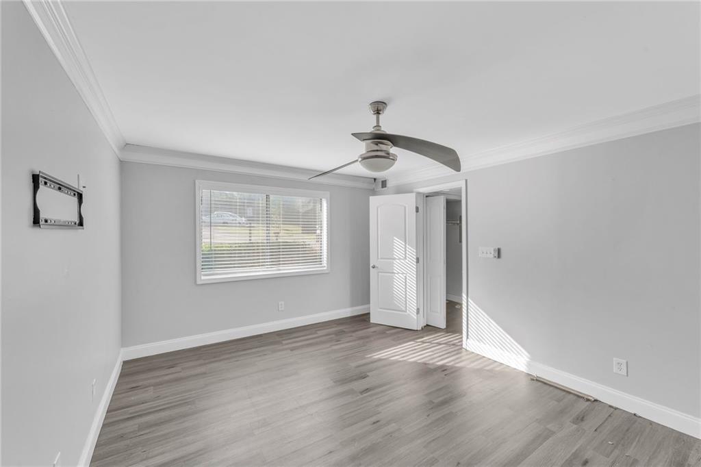 18 Quail Run, Unit A Decatur, GA 30035 - Photo 27 of 28 a view of an empty room with wooden floor and a window