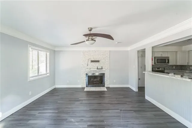 a view of kitchen with sink microwave and cabinets