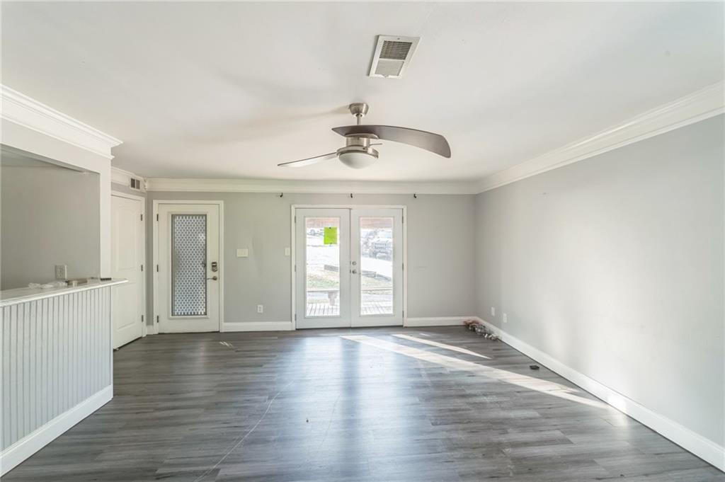 18 Quail Run, Unit A Decatur, GA 30035 - Photo 5 of 28 a view of an empty room with wooden floor and a window