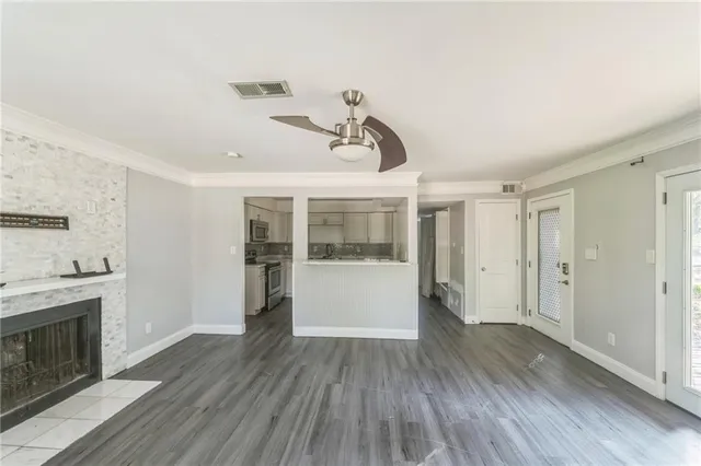 a view of empty room with wooden floor and fireplace