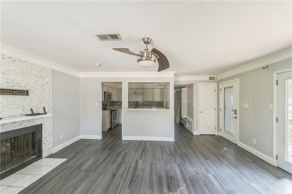 18 Quail Run, Unit A Decatur, GA 30035 - Photo 7 of 28 a view of empty room with wooden floor and fireplace