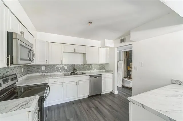 a kitchen with a sink stove and cabinets
