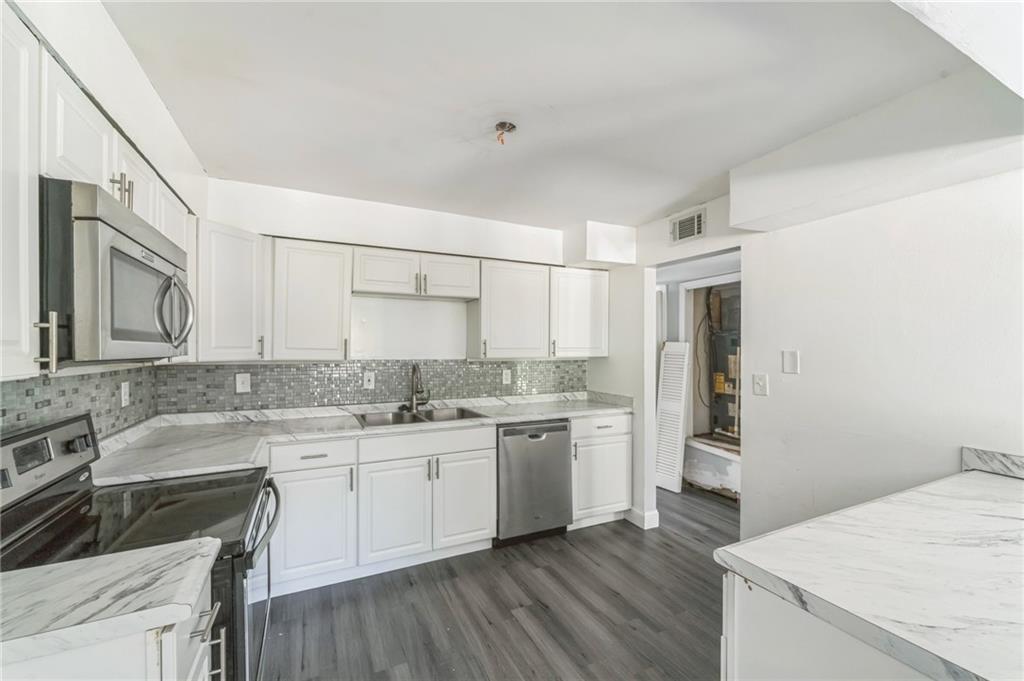 18 Quail Run, Unit A Decatur, GA 30035 - Photo 8 of 28 a kitchen with a sink stove and cabinets