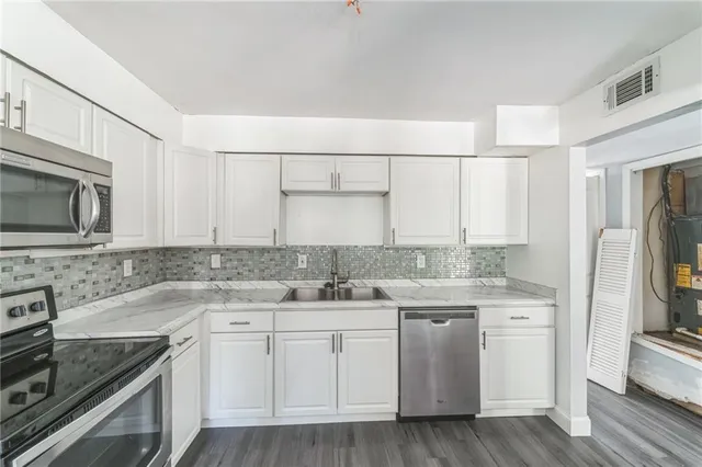 a kitchen with a sink stove and refrigerator
