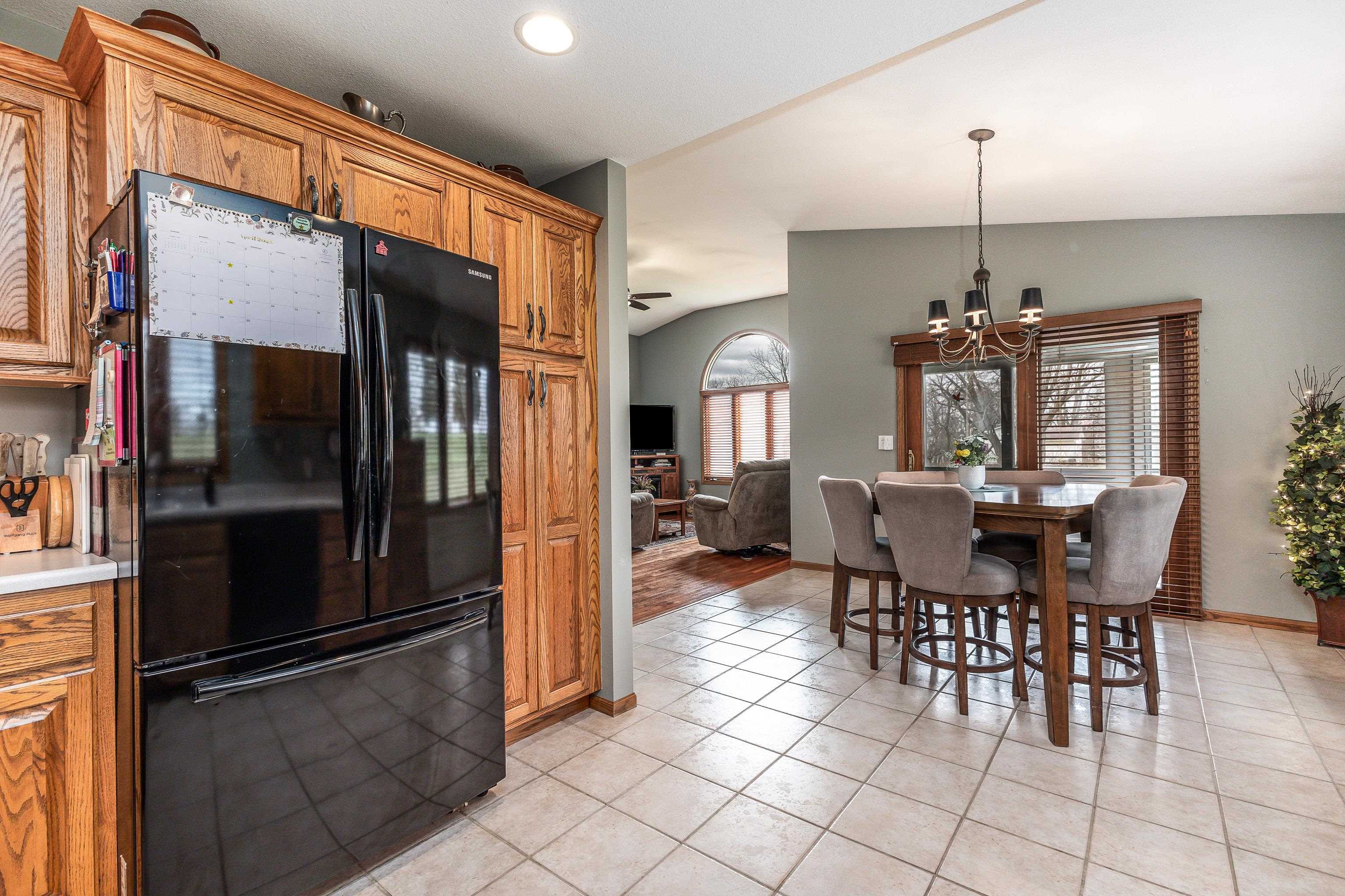 825 Shadow Bluff Drive Galena, IL 61036 - Photo 11 of 37 a view of a dining room with furniture window and wooden floor