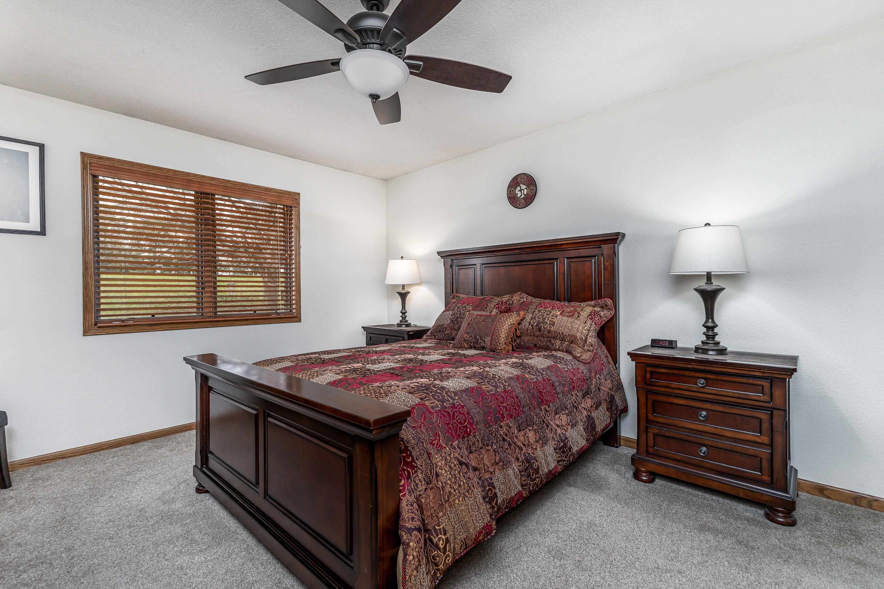 825 Shadow Bluff Drive Galena, IL 61036 - Photo 16 of 37 a bedroom with a bed and a chandelier