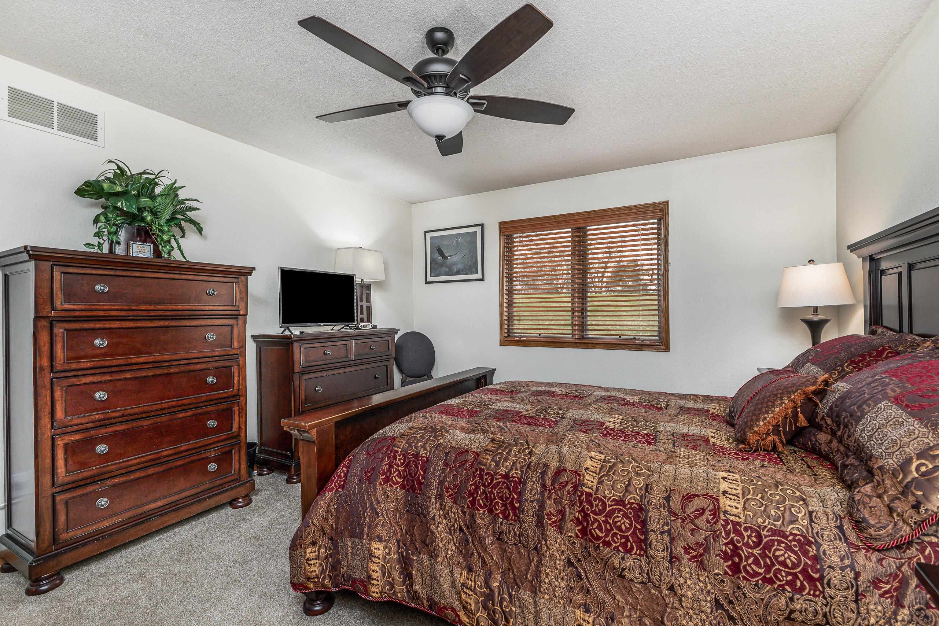 825 Shadow Bluff Drive Galena, IL 61036 - Photo 18 of 37 a bedroom with a bed and a flat screen tv