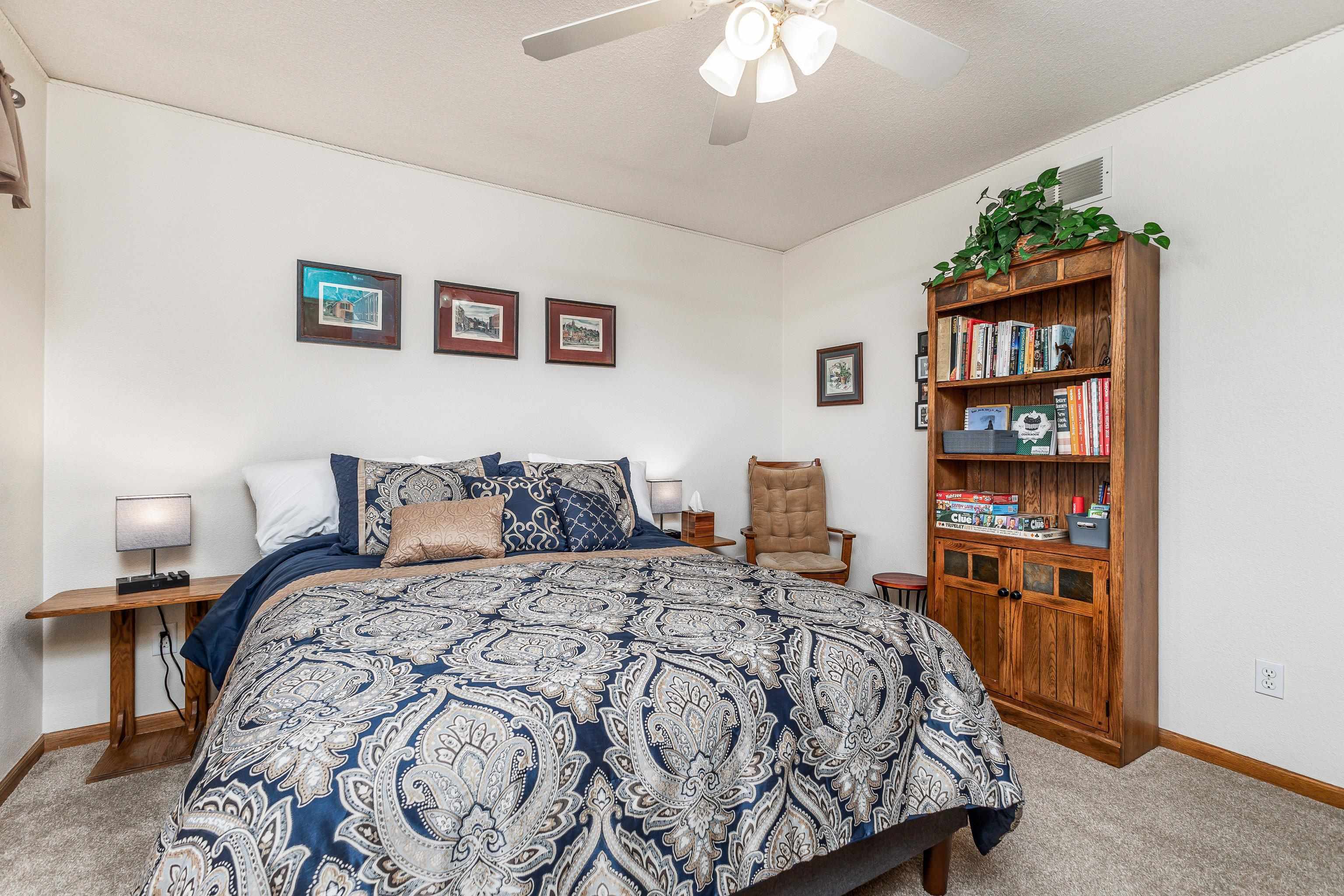 825 Shadow Bluff Drive Galena, IL 61036 - Photo 21 of 37 a bed sitting in a bedroom next to a book shelf