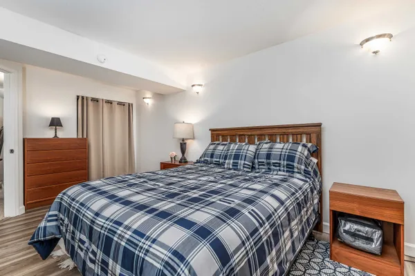 a bedroom with a bed and a night stand