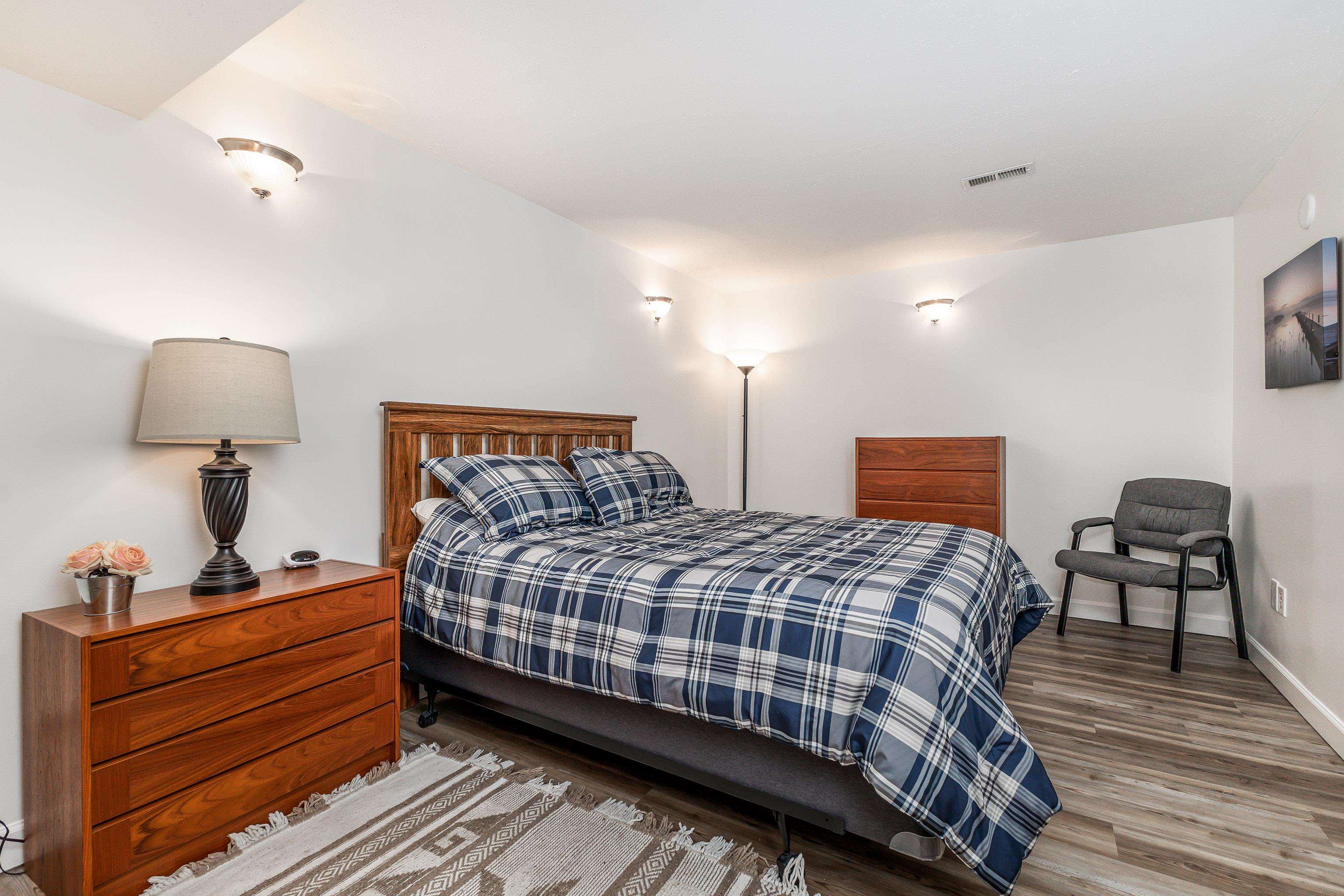 825 Shadow Bluff Drive Galena, IL 61036 - Photo 30 of 37 a bedroom with a bed a lamp and a dresser