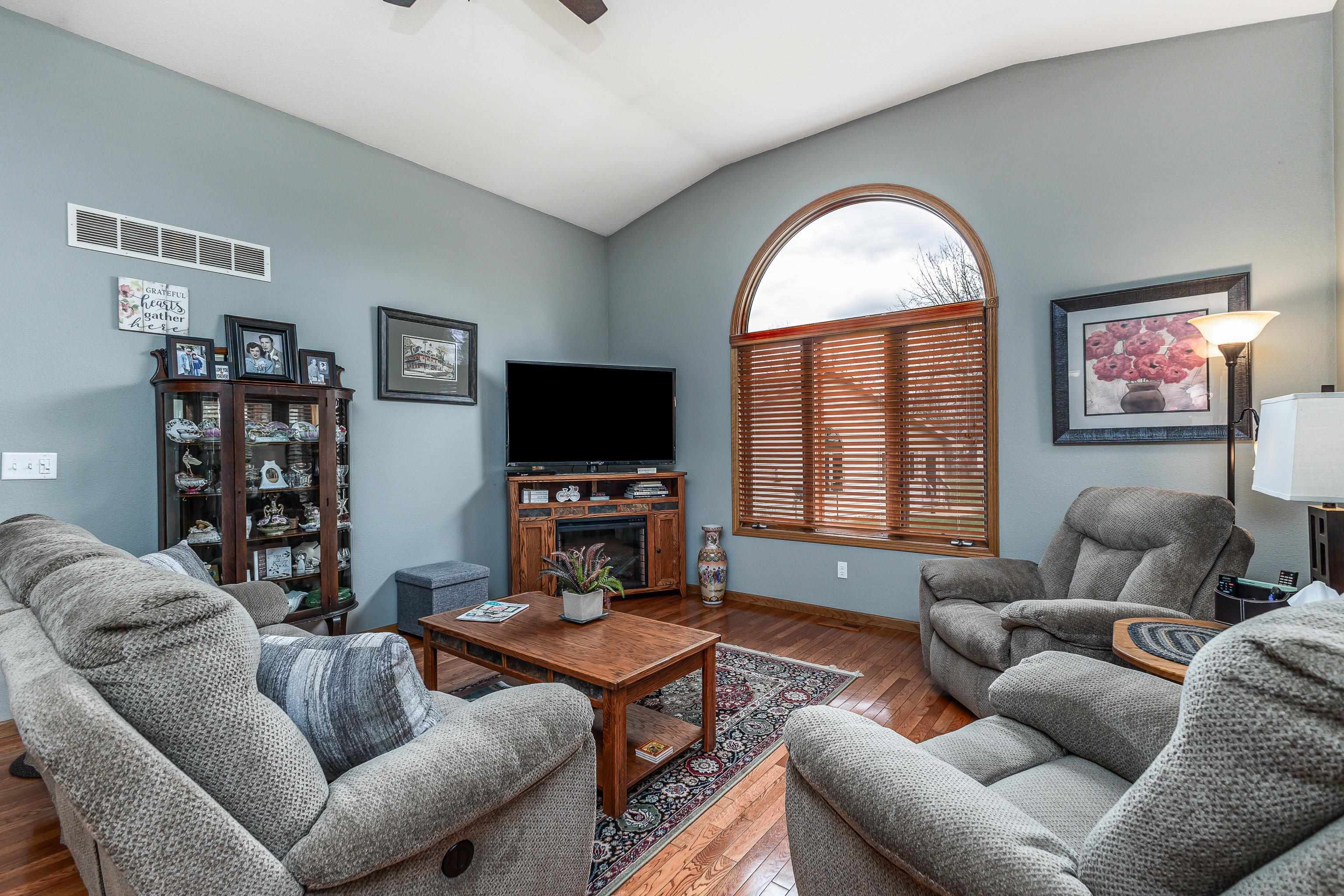 825 Shadow Bluff Drive Galena, IL 61036 - Photo 3 of 37 a living room with furniture a large window and a flat screen tv