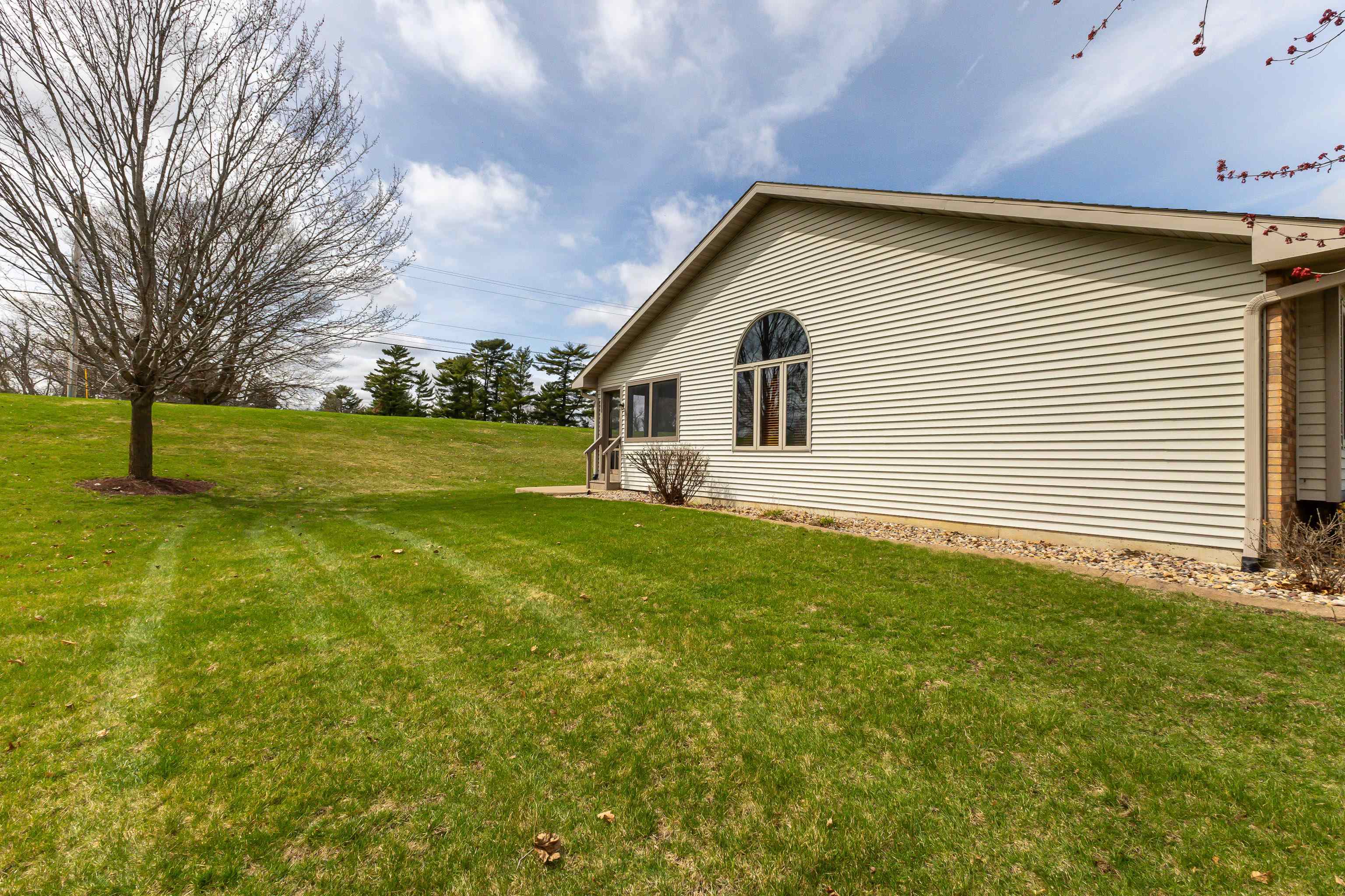 825 Shadow Bluff Drive Galena, IL 61036 - Photo 36 of 37 a front view of house with yard and trees in the background