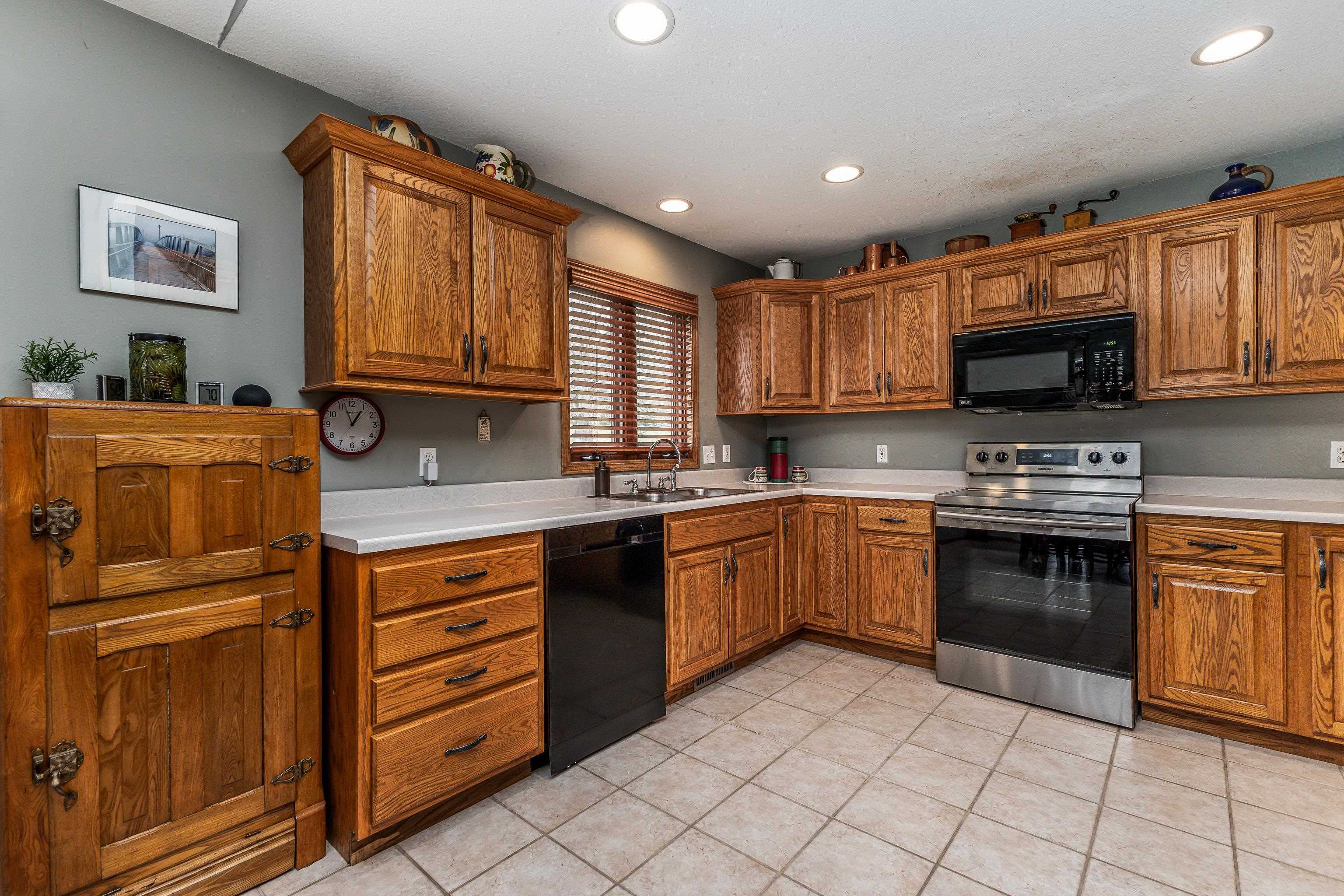 825 Shadow Bluff Drive Galena, IL 61036 - Photo 8 of 37 a kitchen with stainless steel appliances granite countertop a stove sink and cabinets