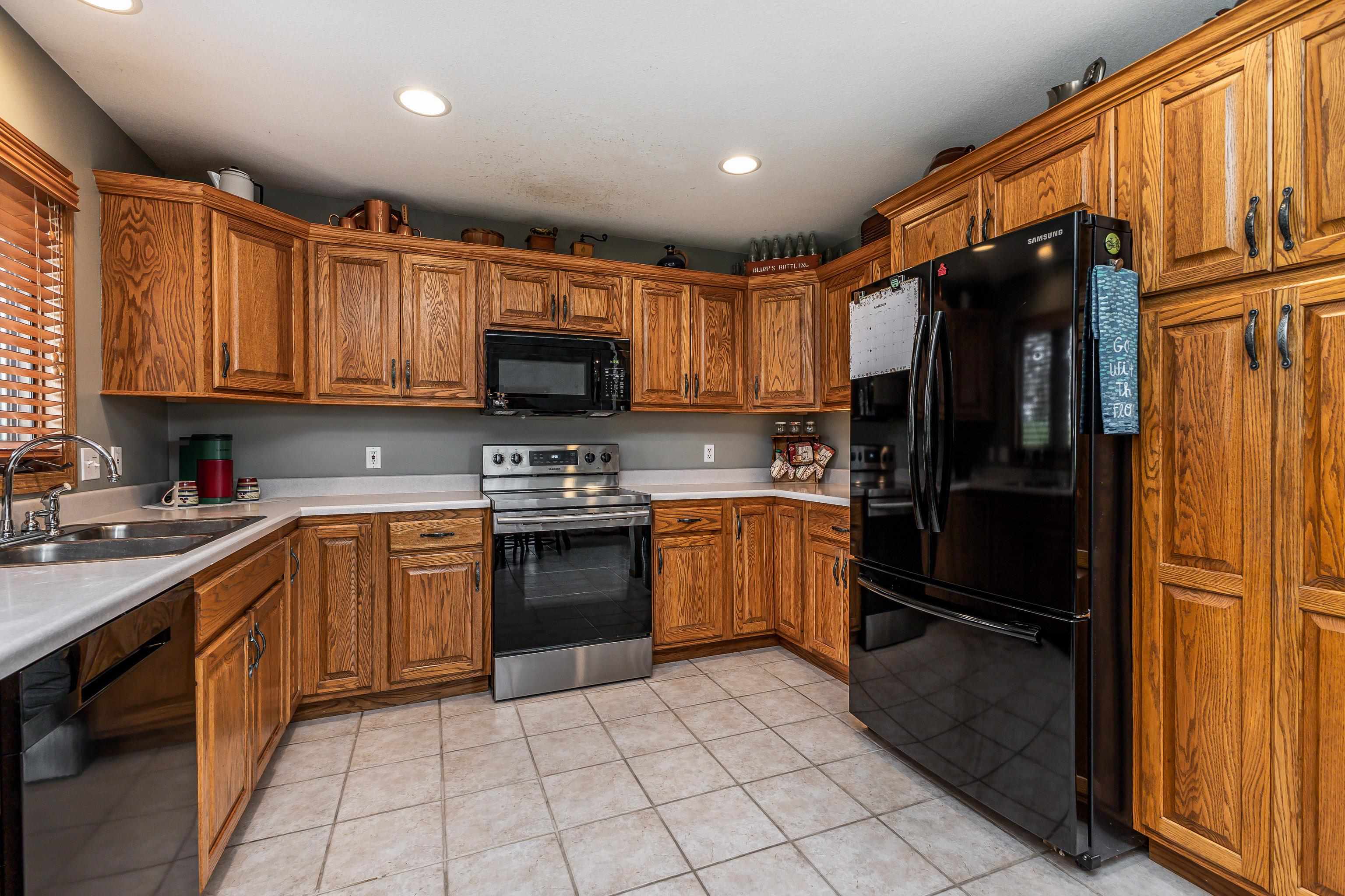 825 Shadow Bluff Drive Galena, IL 61036 - Photo 9 of 37 a kitchen with stainless steel appliances granite countertop a refrigerator stove top oven and sink