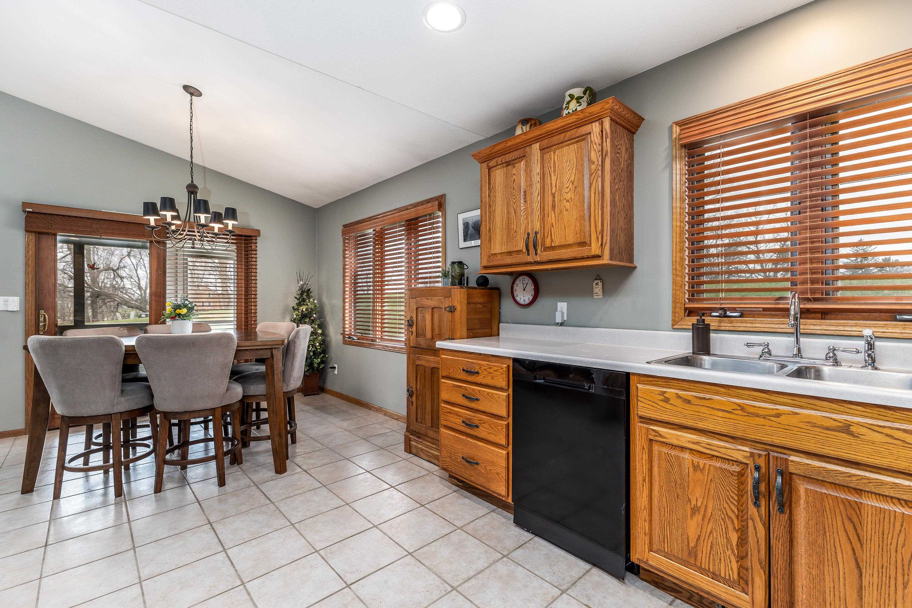 825 Shadow Bluff Drive Galena, IL 61036 - Photo 10 of 37 a kitchen with cabinets a sink dining table and chairs