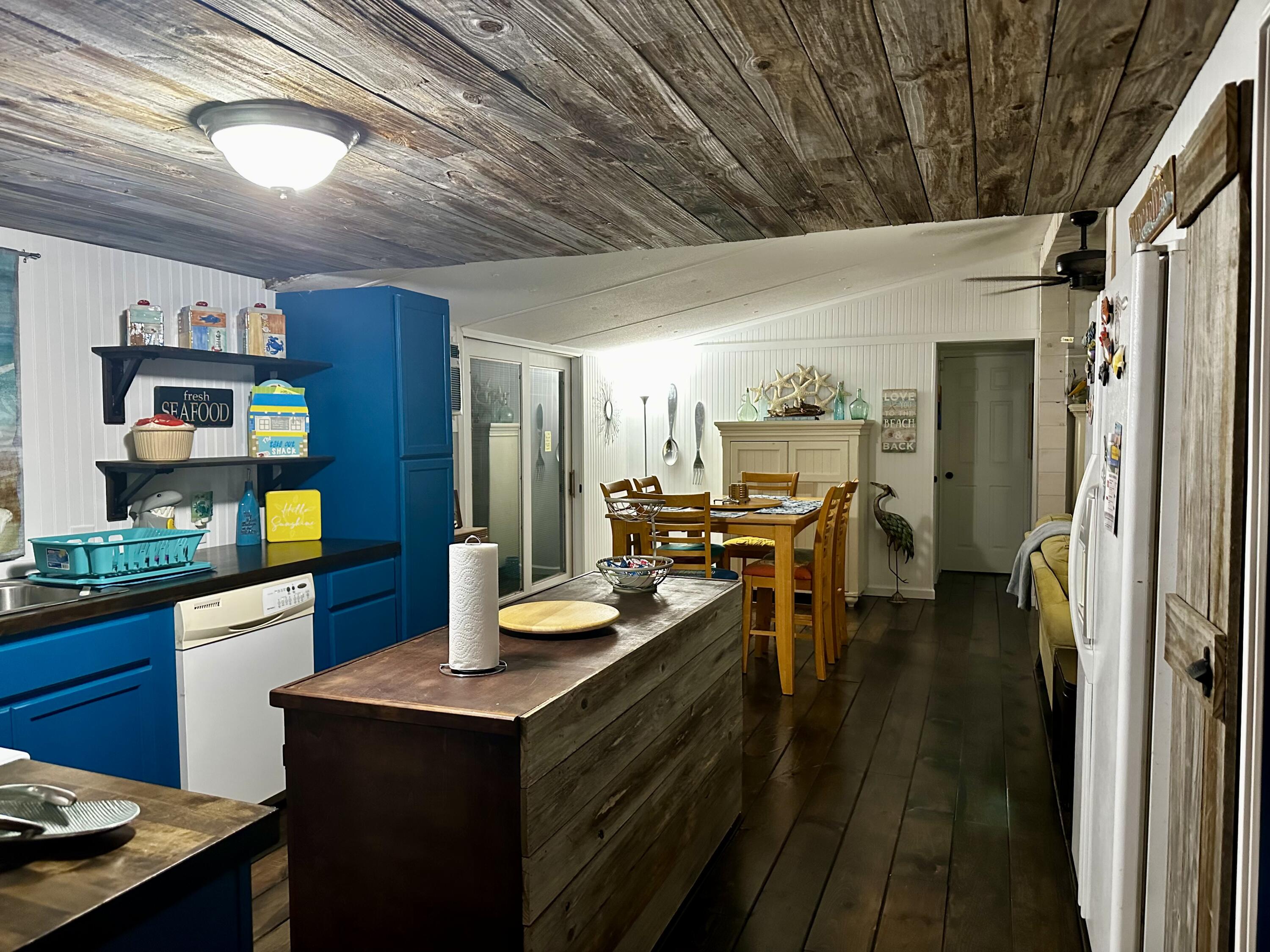 a kitchen with a refrigerator a stove and cabinets