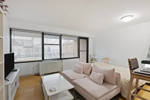 a living room with furniture and kitchen view