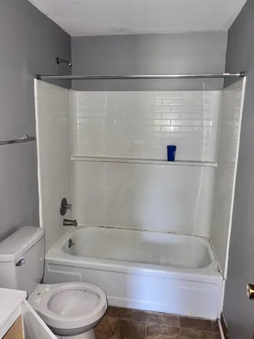 a bathroom with a bathtub and a toilet
