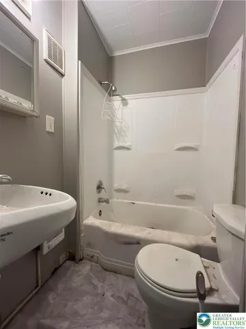 a bathroom with a toilet and a bathtub