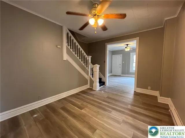 a view of empty room with wooden floor