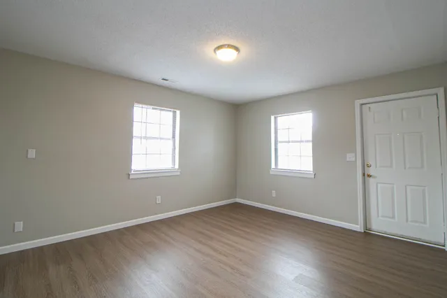 a kitchen with granite countertop white cabinets and white appliances